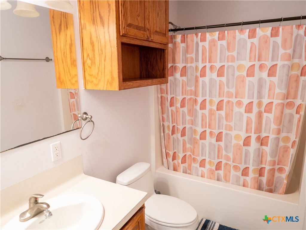 2507 Boyd Road Port Lavaca, TX 77979 - Photo 36 of 47 a white toilet sitting next to a bathroom sink and a shower