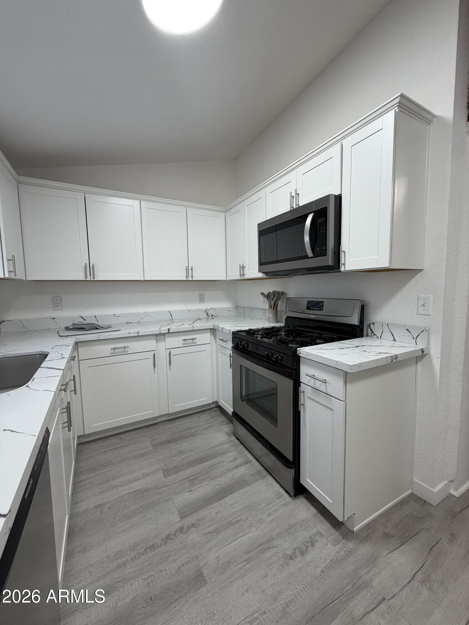 360 Pinal Street Globe, AZ 85501 - Photo 2 of 13 a kitchen with stainless steel appliances white cabinets a sink and a stove