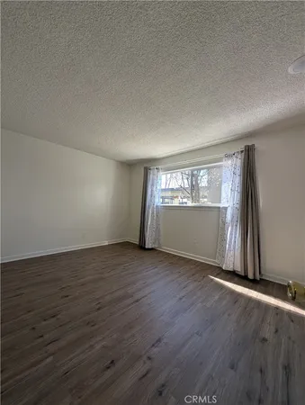 a view of an empty room and wooden floor