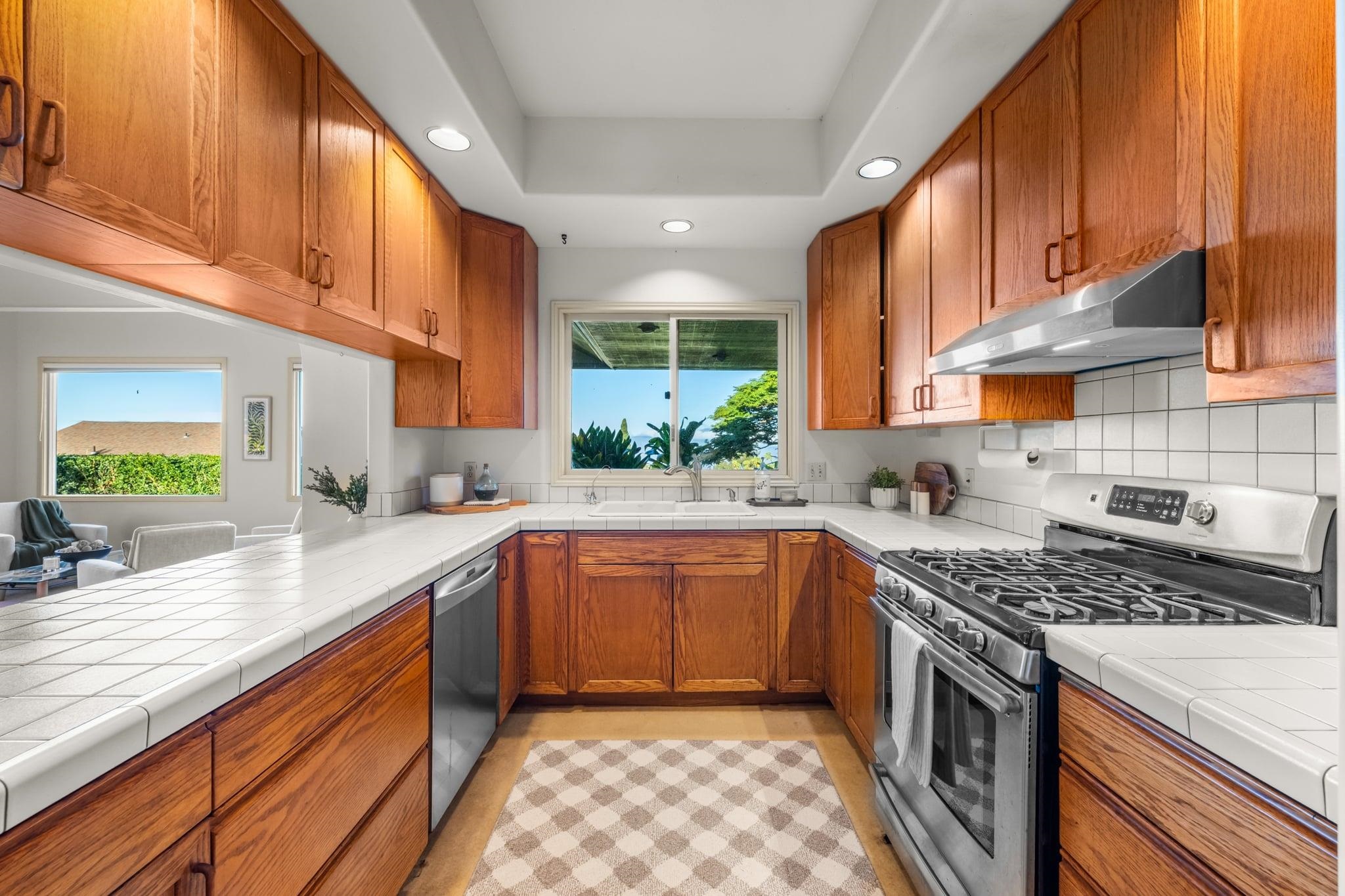 33 Puakea Place Kula, HI 96790 - Photo 13 of 48 a kitchen with stainless steel appliances granite countertop a sink stove and cabinets