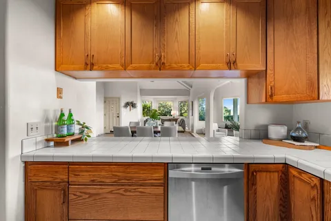 a kitchen with stainless steel appliances granite countertop a sink and cabinets