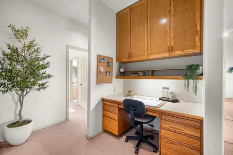a view of a workspace with furniture and a potted plant