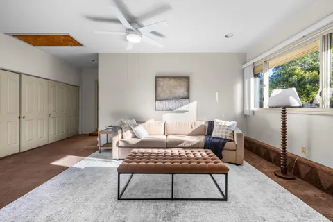 a living room with furniture rug and window