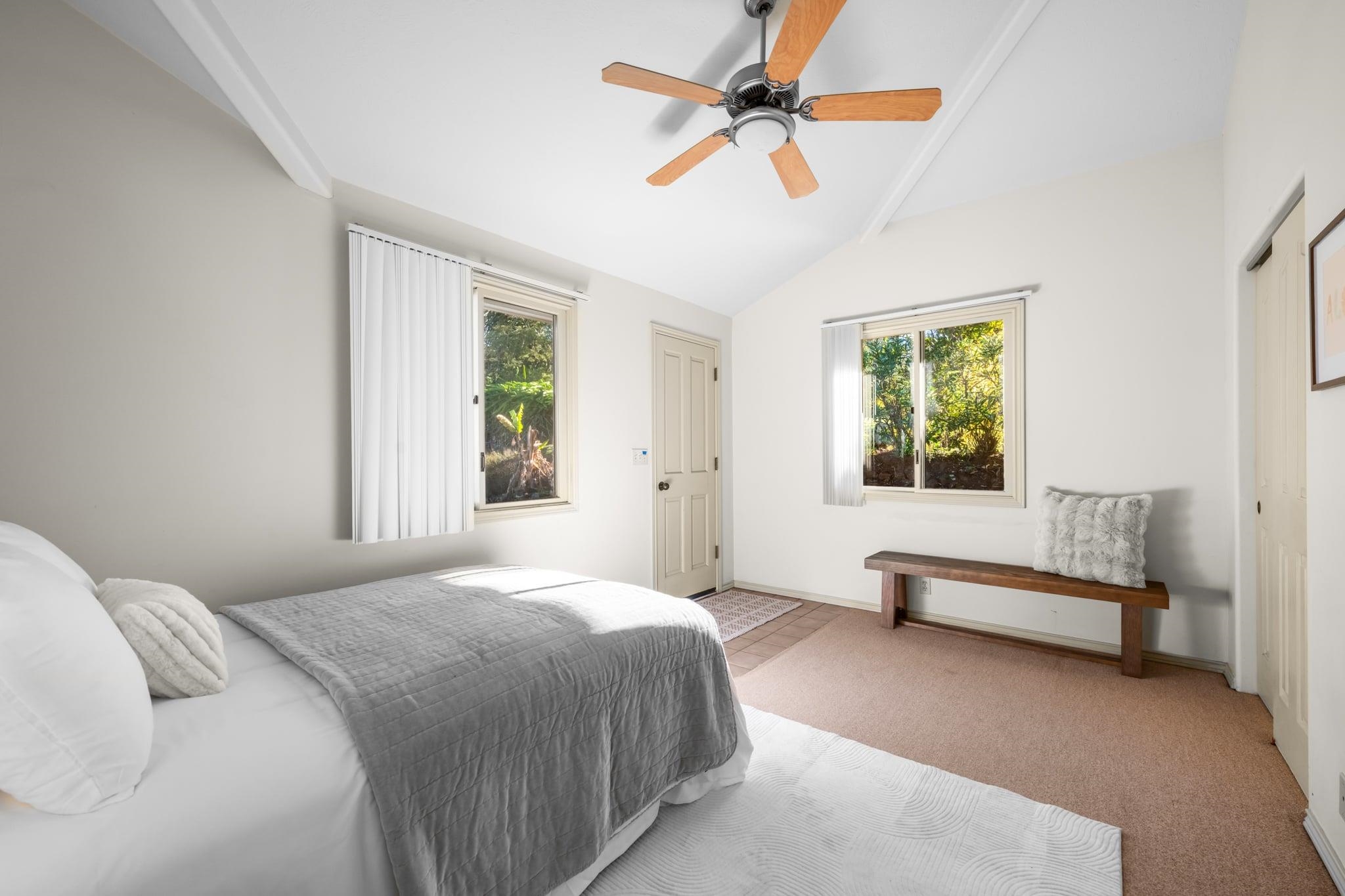 33 Puakea Place Kula, HI 96790 - Photo 22 of 48 a bedroom with a bed a couch and a window