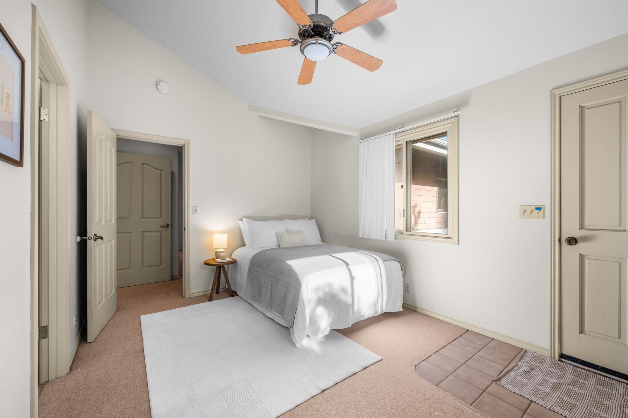 33 Puakea Place Kula, HI 96790 - Photo 23 of 48 a bedroom with a bed and a chandelier