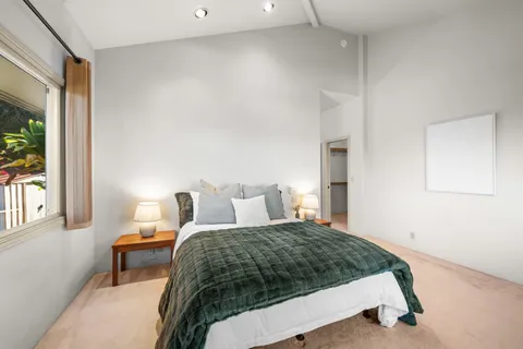 a bedroom with a bed and window