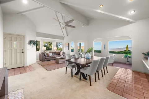 a living room with lots of furniture and a large window