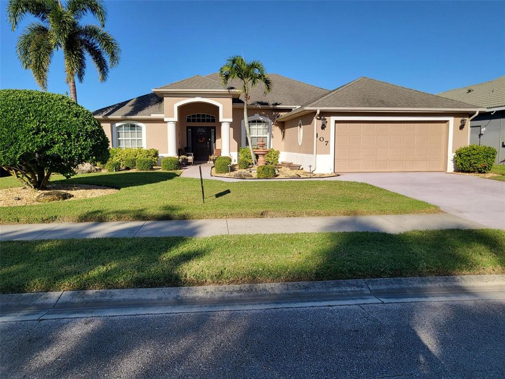 107 Wading Bird Drive Venice, FL 34292 - Photo 1 of 33 a front view of a house with garden