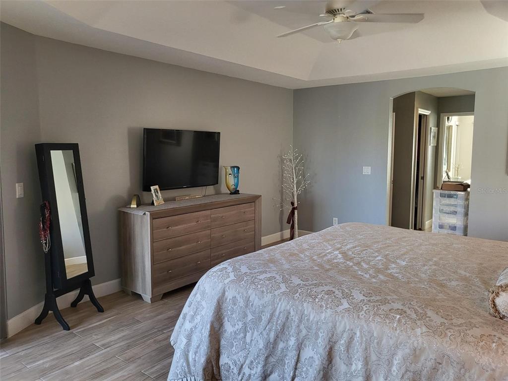 107 Wading Bird Drive Venice, FL 34292 - Photo 12 of 33 a bedroom with a bed and a flat screen tv