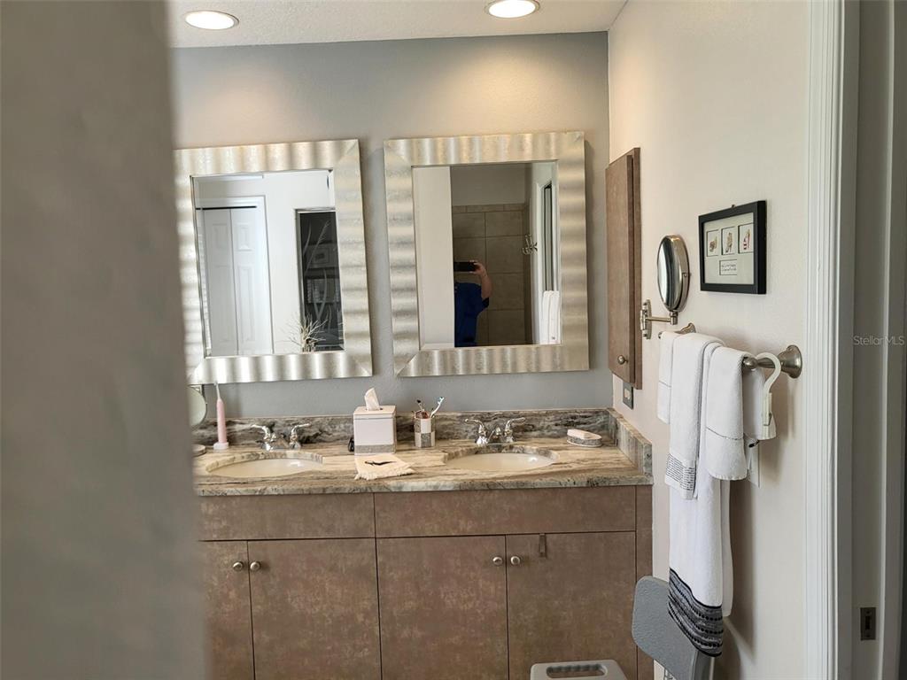 107 Wading Bird Drive Venice, FL 34292 - Photo 17 of 33 a bathroom with a sink and a mirror