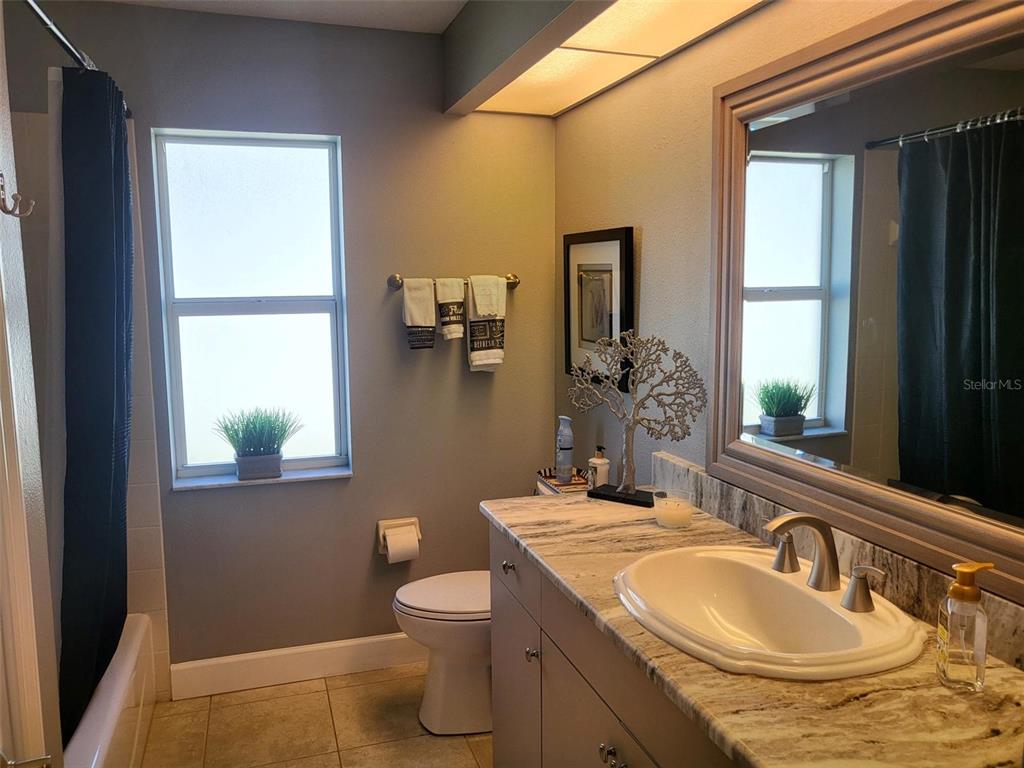 107 Wading Bird Drive Venice, FL 34292 - Photo 22 of 33 a bathroom with a granite countertop sink and a mirror