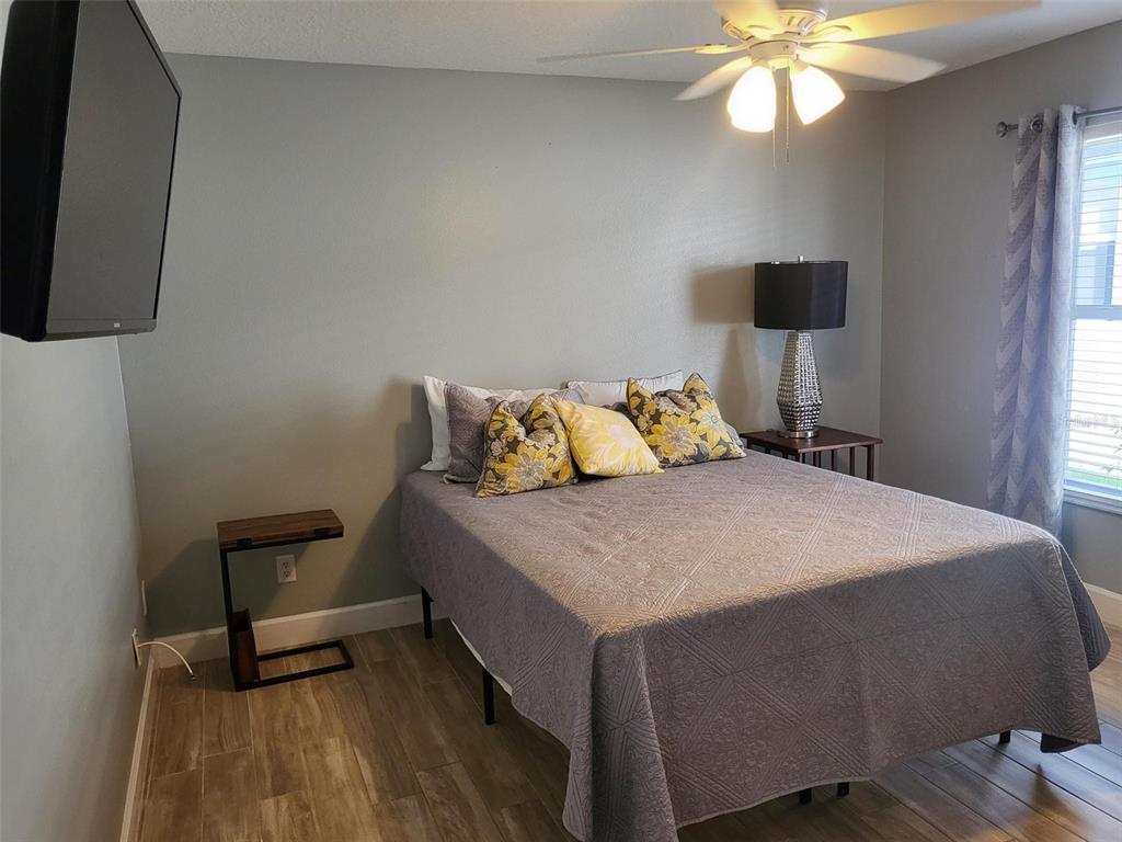 107 Wading Bird Drive Venice, FL 34292 - Photo 24 of 33 a bedroom with a bed and a chandelier