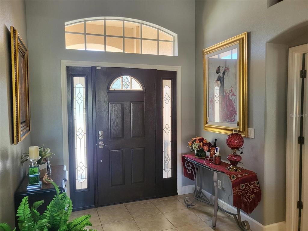 107 Wading Bird Drive Venice, FL 34292 - Photo 3 of 33 a hallway with beautiful frames and flower vase