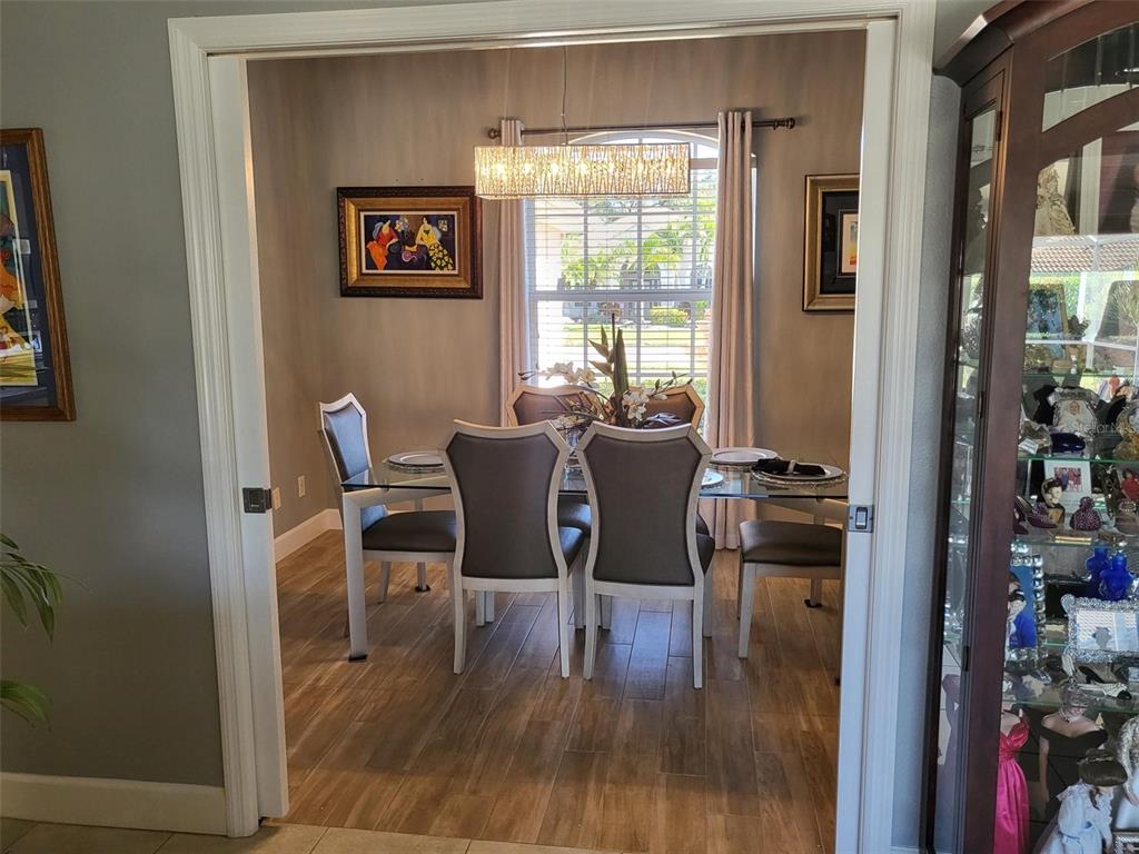 107 Wading Bird Drive Venice, FL 34292 - Photo 6 of 33 a view of a dining room with furniture window and wooden floor
