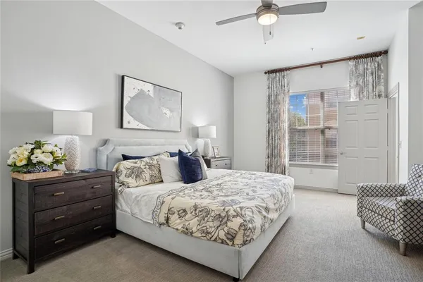 a bedroom with a bed and ceiling fan