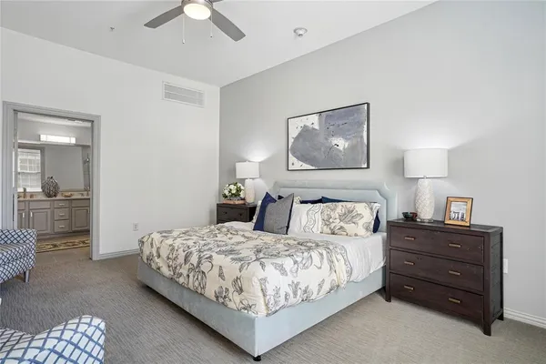 a bedroom with a bed and cabinet