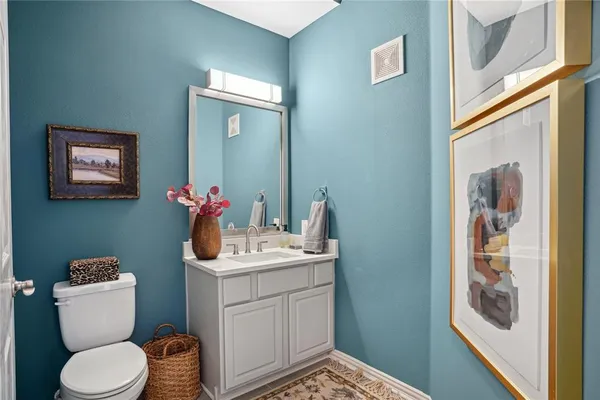 a bathroom with a sink toilet and mirror