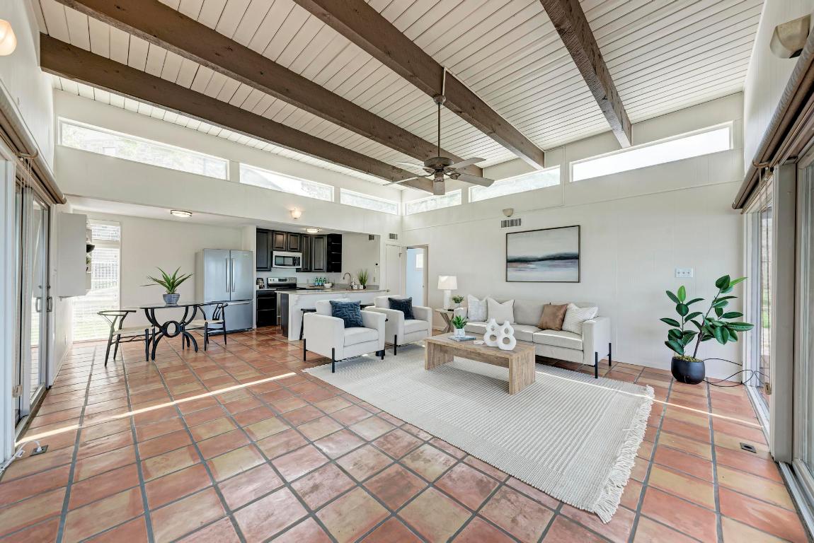 8130 Joy Road Volente, TX 78641 - Photo 12 of 36 Living room with a high ceiling, ceiling fan, beam ceiling, and light tile patterned flooring