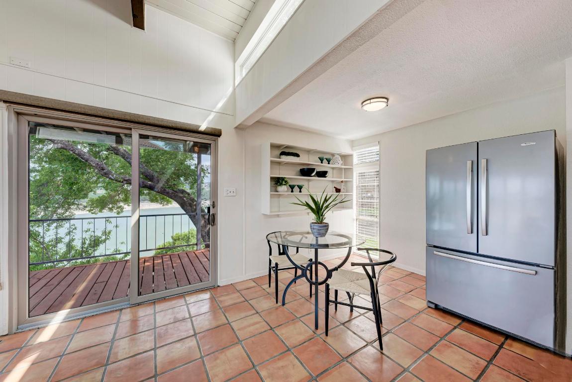 8130 Joy Road Volente, TX 78641 - Photo 14 of 36 Dining room featuring light tile patterned flooring, beamed ceiling, and a textured ceiling