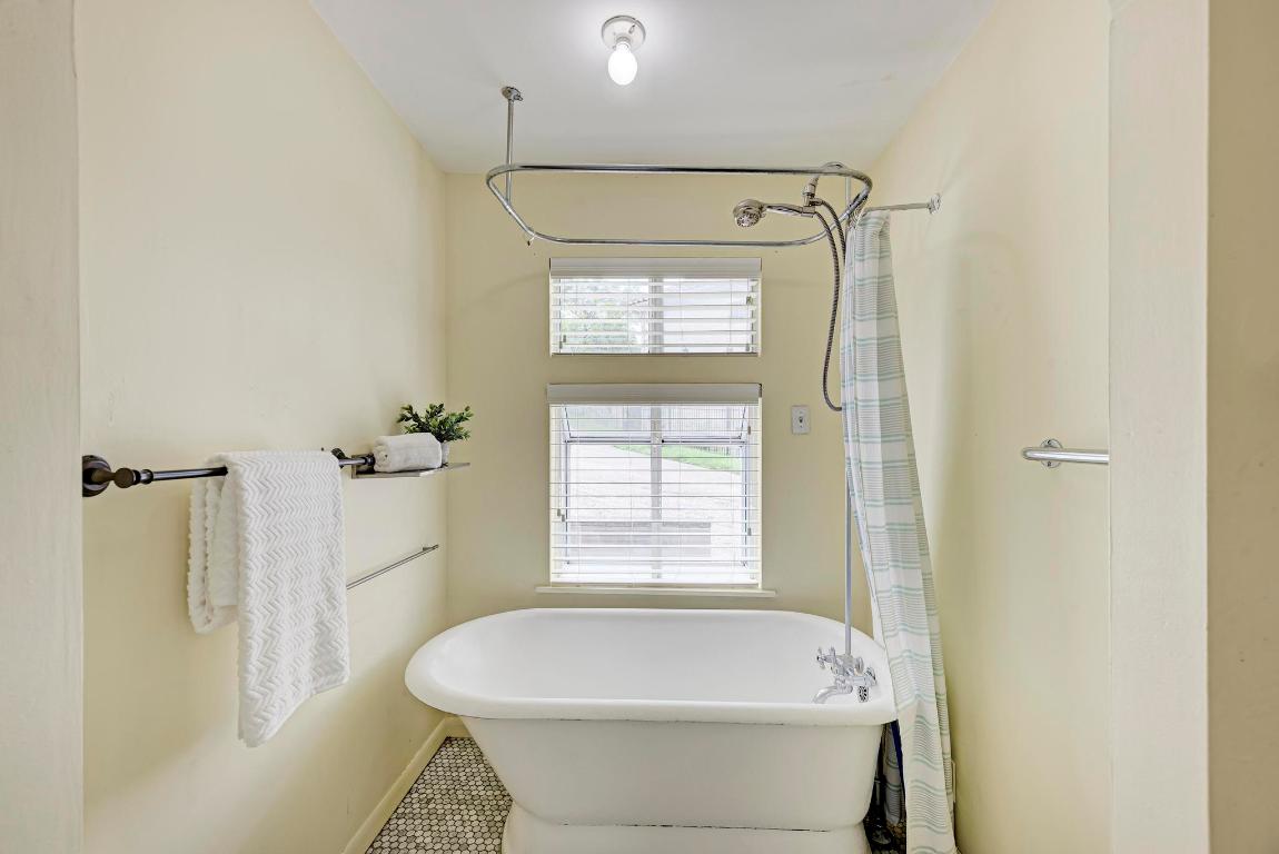 8130 Joy Road Volente, TX 78641 - Photo 23 of 36 Full bathroom with a freestanding tub, tile patterned floors, and a shower with curtain