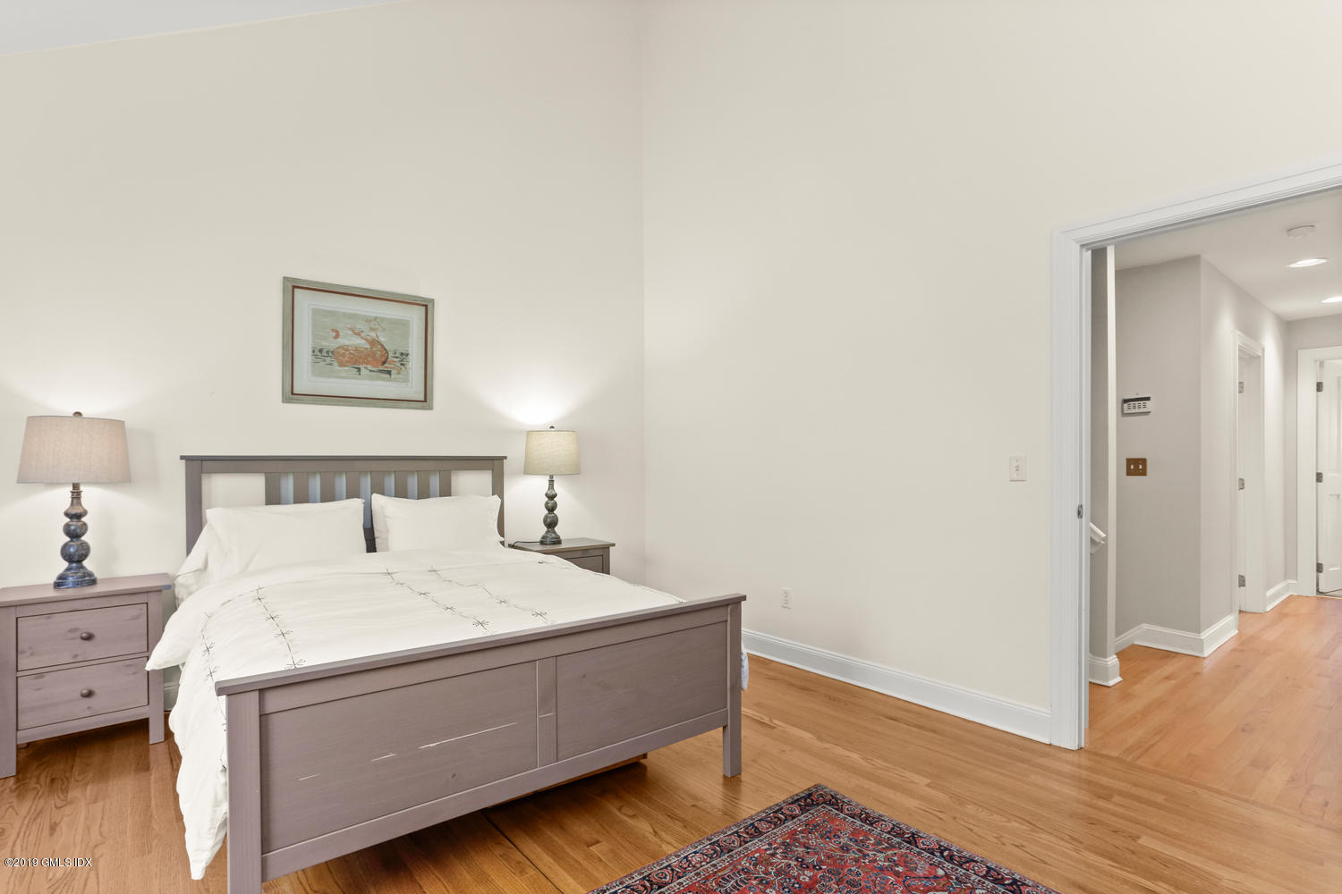 333 Palmer Hill Road, Unit 3C Riverside, CT 06878 - Photo 13 of 36 a room with a bed and a lamp on dresser