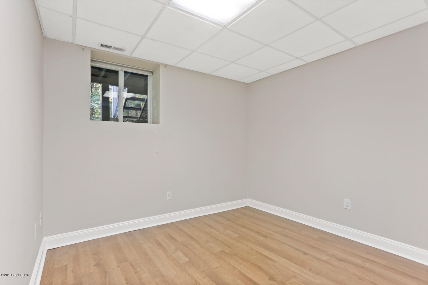 333 Palmer Hill Road, Unit 3C Riverside, CT 06878 - Photo 20 of 36 a view of an empty room with wooden floor and a window