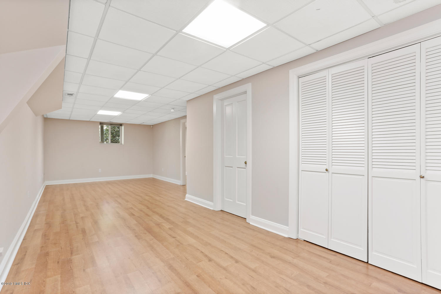 333 Palmer Hill Road, Unit 3C Riverside, CT 06878 - Photo 23 of 36 an empty room with wooden floor and windows
