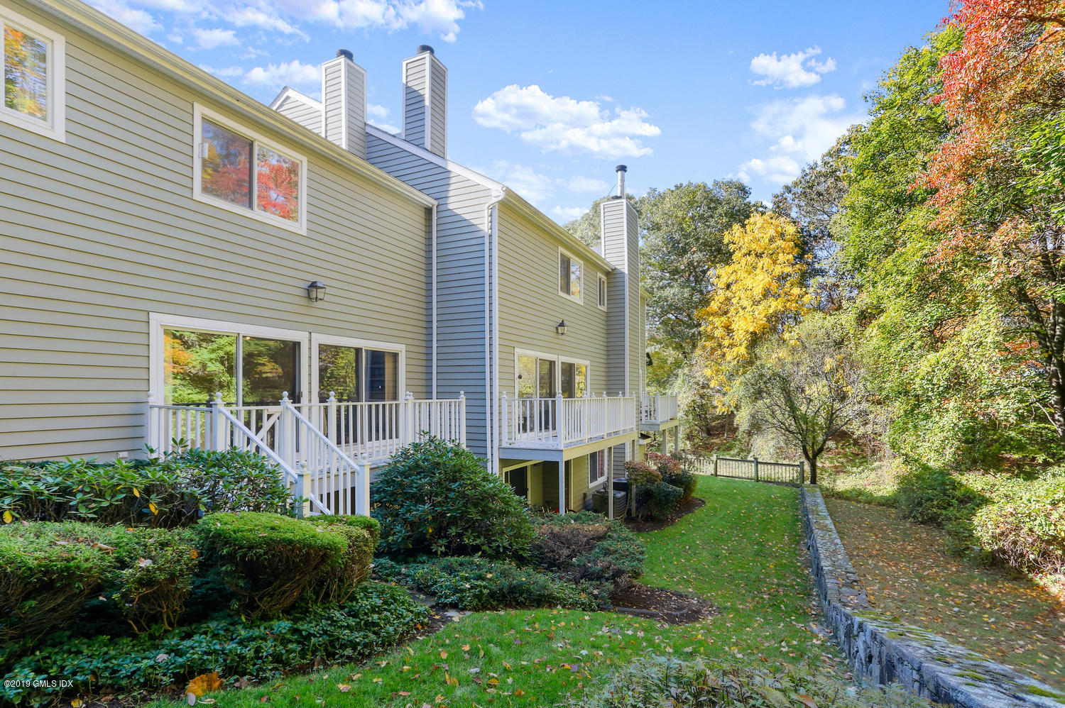 333 Palmer Hill Road, Unit 3C Riverside, CT 06878 - Photo 29 of 36 a front view of a house with plants and trees