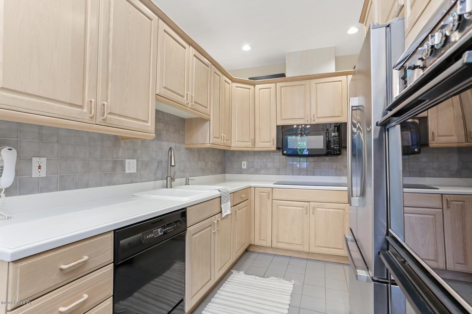 333 Palmer Hill Road, Unit 3C Riverside, CT 06878 - Photo 3 of 36 a kitchen with a sink cabinets and stainless steel appliances