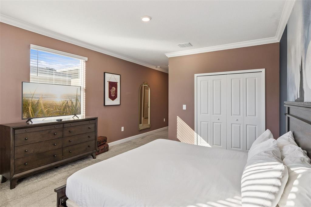 4378 Rhyme Street Kissimmee, FL 34746 - Photo 14 of 41 a bedroom with a bed and a mirror on dresser