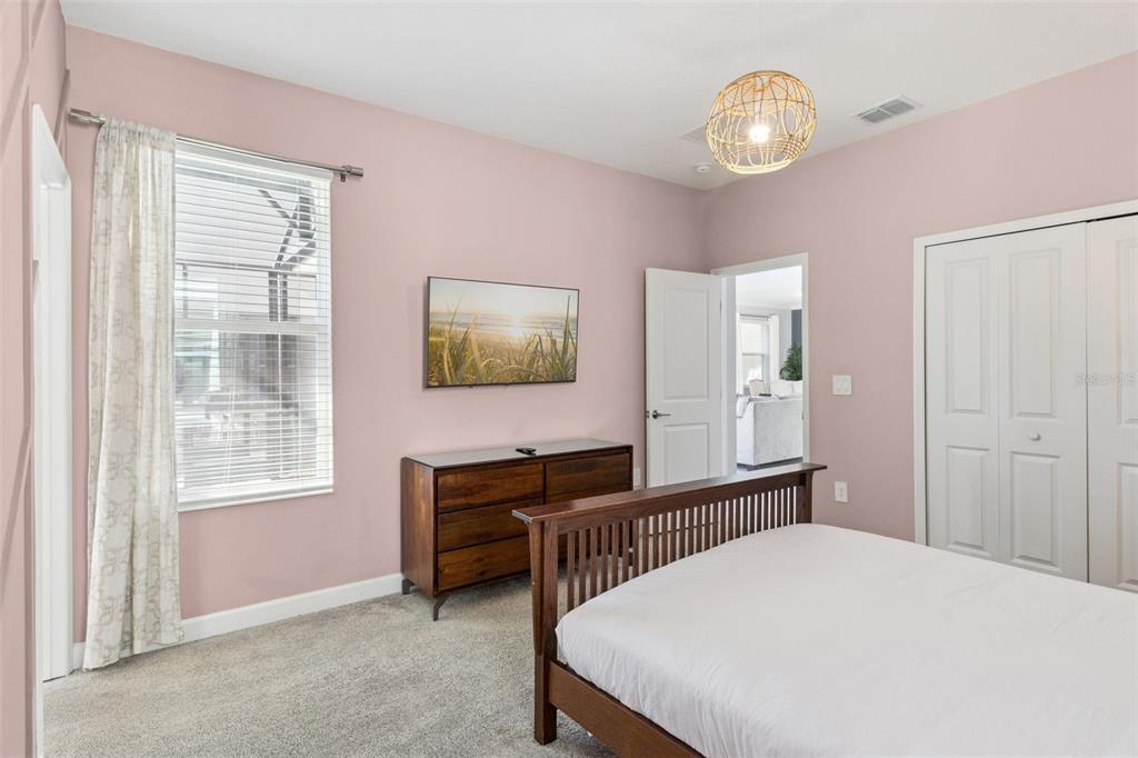 4378 Rhyme Street Kissimmee, FL 34746 - Photo 16 of 41 a bedroom with a bed and a chandelier