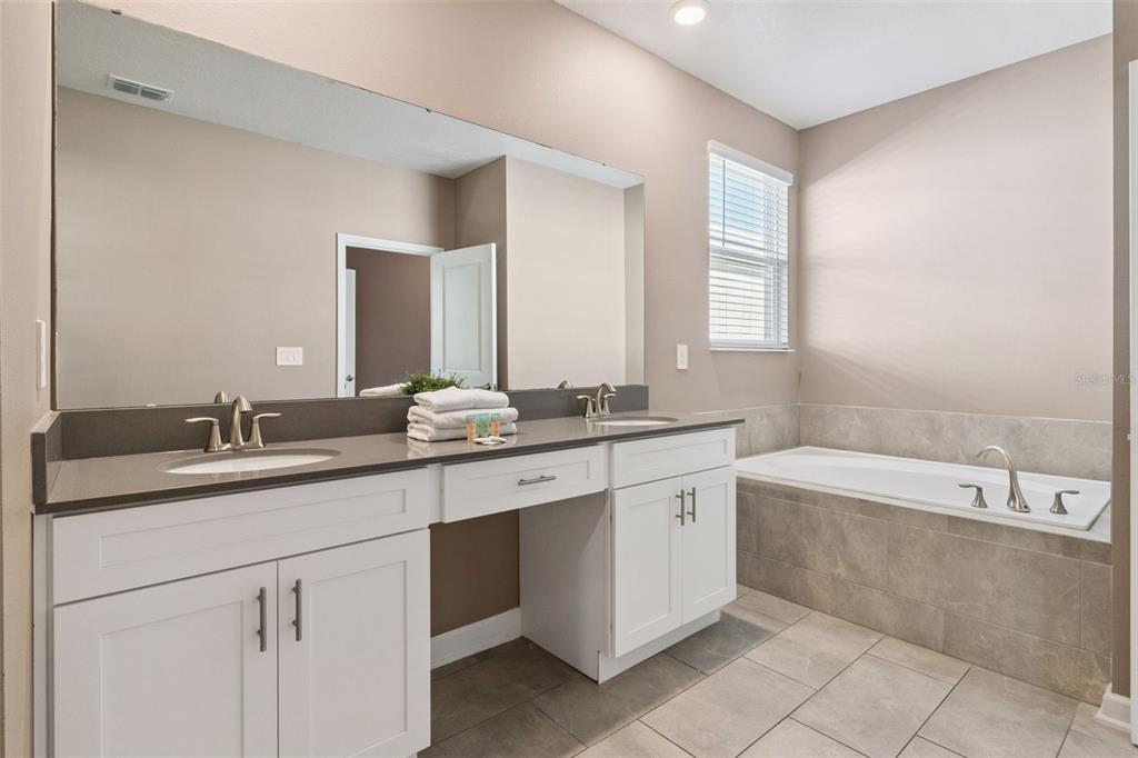 4378 Rhyme Street Kissimmee, FL 34746 - Photo 24 of 41 a bathroom with a granite countertop sink mirror and bathtub