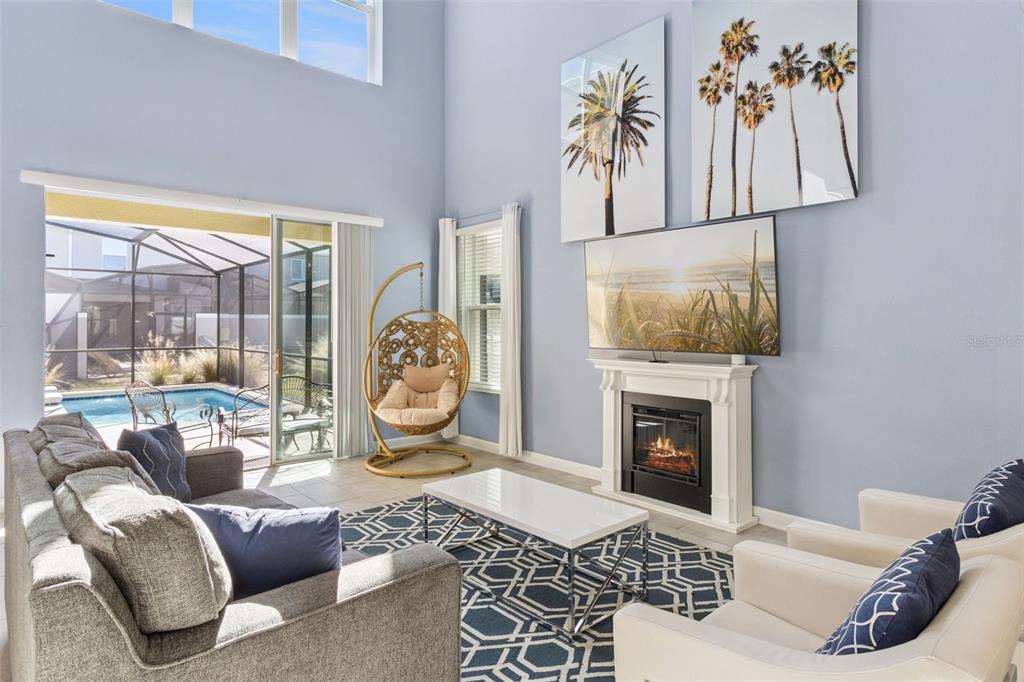 4378 Rhyme Street Kissimmee, FL 34746 - Photo 4 of 41 a living room with furniture and a fireplace