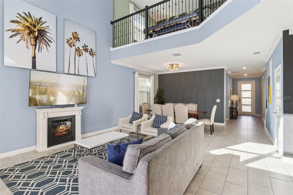 4378 Rhyme Street Kissimmee, FL 34746 - Photo 5 of 41 a living room with furniture a flat screen tv and a fireplace