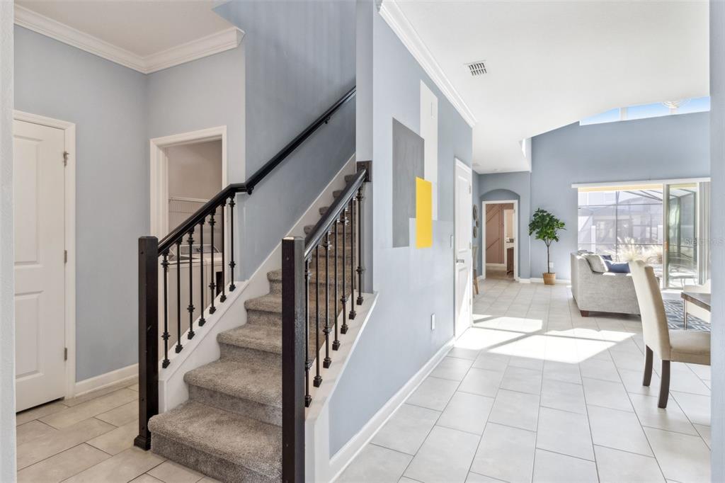 4378 Rhyme Street Kissimmee, FL 34746 - Photo 10 of 41 a view of a hallway with dining room and stairs