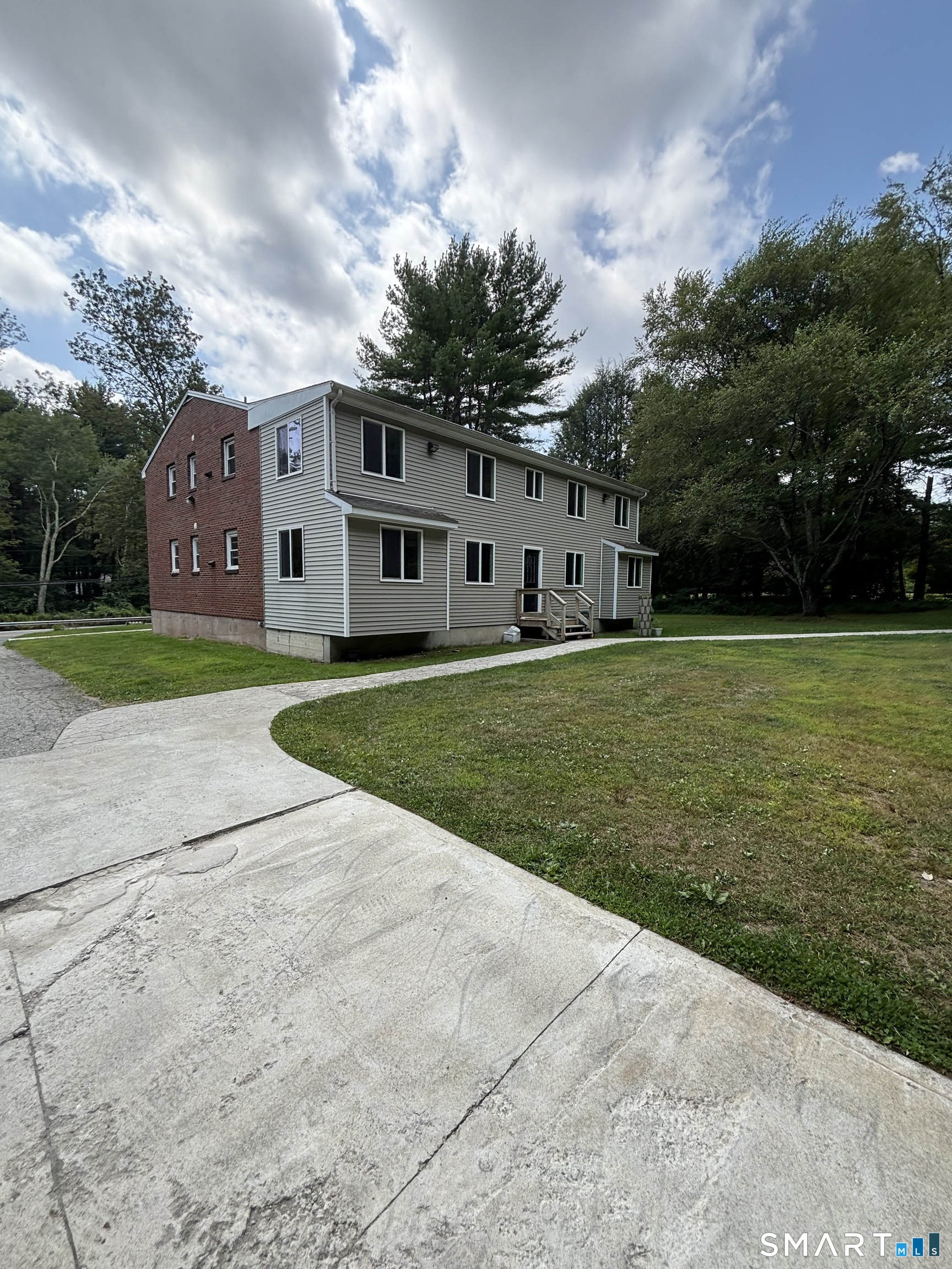 a front view of house with yard and green space