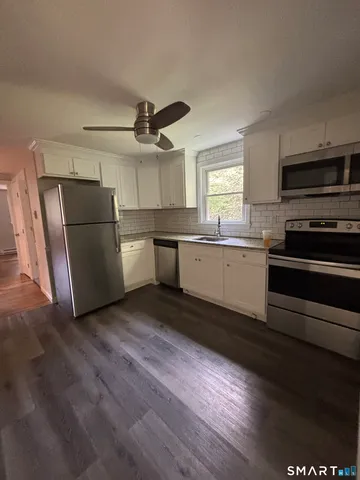 a kitchen with a sink and refrigerator