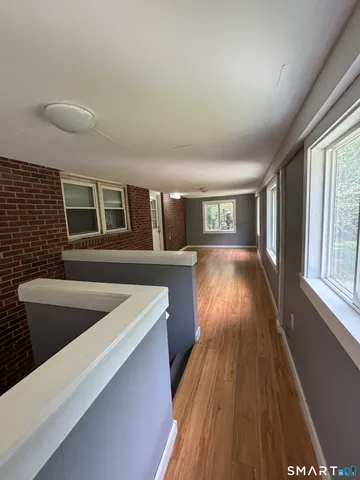 a view of a kitchen with a sink and wooden floor