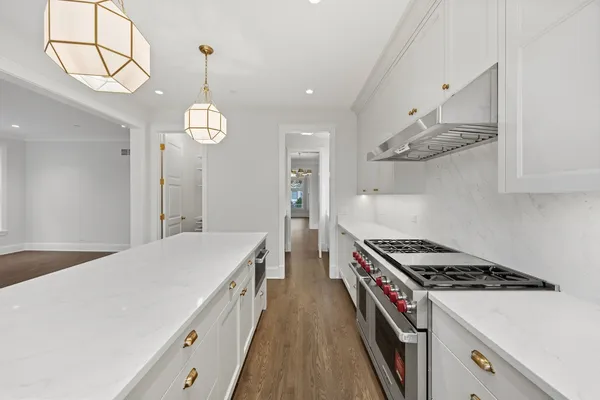 a kitchen with stainless steel appliances a stove a sink and a refrigerator