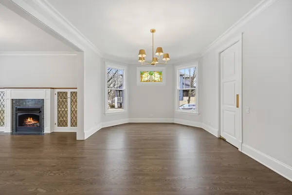 a view of a room with wooden floors and fireplace