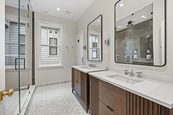 a bathroom with a shower sink and mirror