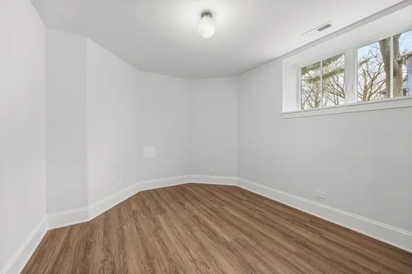 a view of a house with a small yard and wooden fence