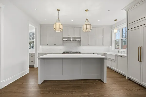 a kitchen with stainless steel appliances granite countertop a sink a refrigerator and a island