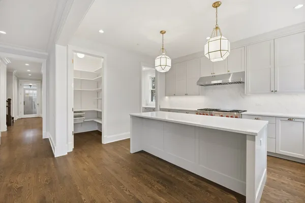 a kitchen with wooden floor and window