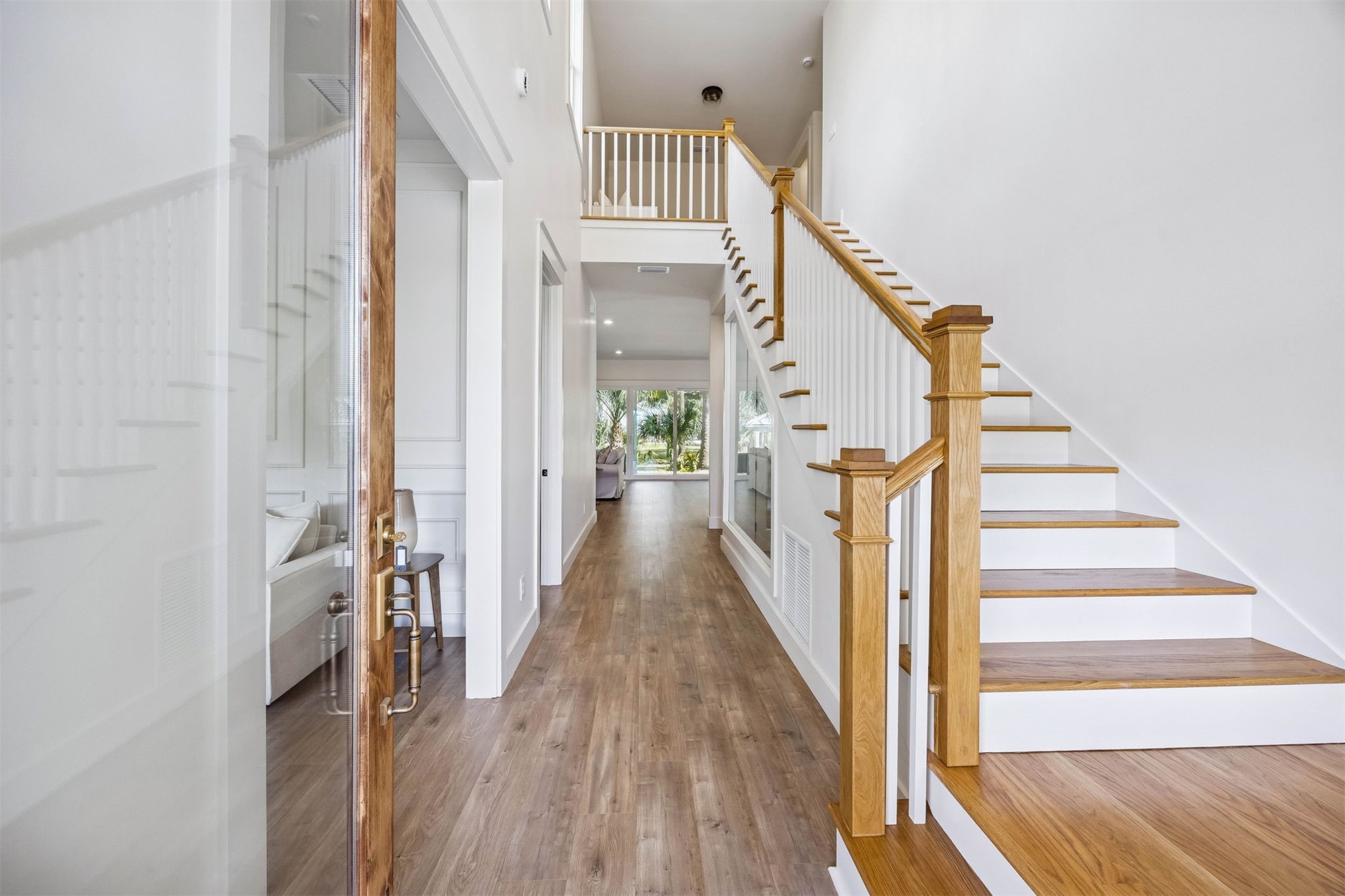 424 South 3rd Street Fernandina Beach, FL 32034 - Photo 2 of 38 a view of a hallway with wooden floor and staircase