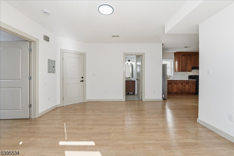 260 South 10th Street, Unit 2 Newark, NJ 07103 - Photo 5 of 26 a view of empty room with kitchen and window