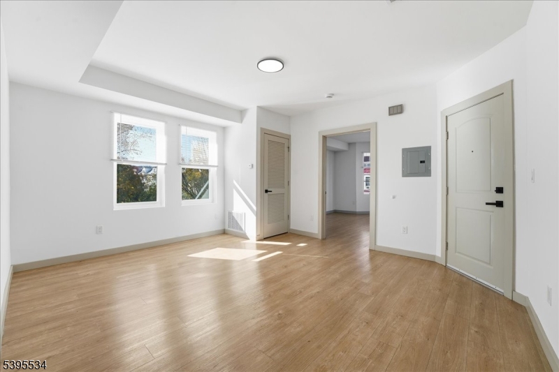 260 South 10th Street, Unit 2 Newark, NJ 07103 - Photo 8 of 26 a view of an empty room with window and wooden floor