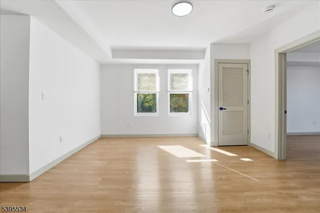 an empty room with windows and closet