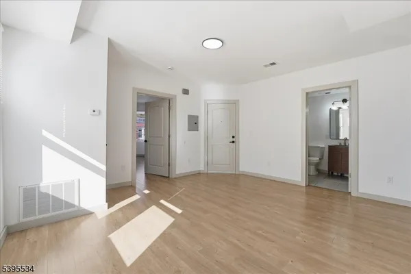 a view of a big room with closet and windows