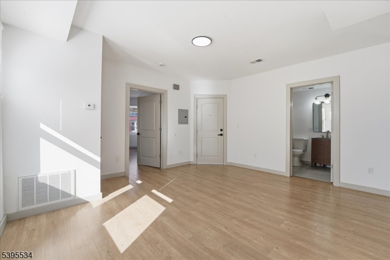 260 South 10th Street, Unit 2 Newark, NJ 07103 - Photo 10 of 26 a view of a big room with closet and windows